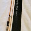 A fishing rod and a white cloth on the table